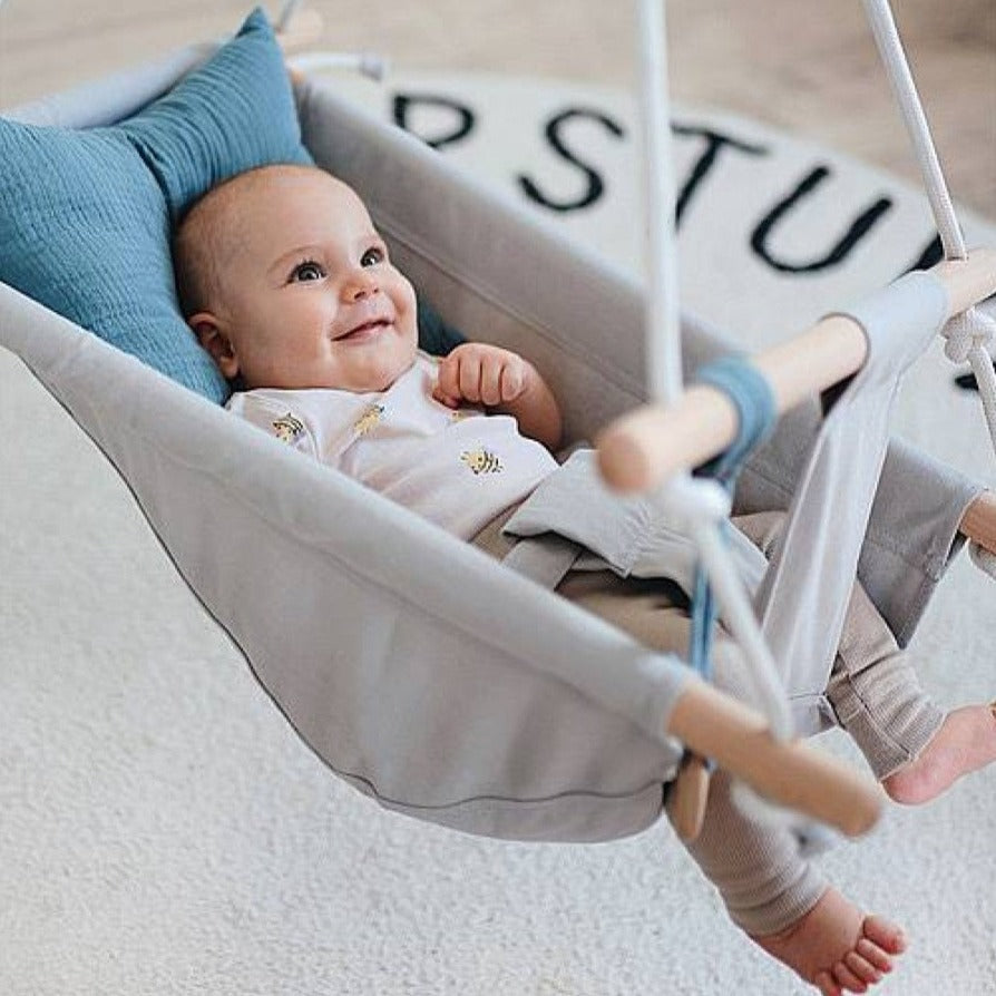 Small foot: a swing with a soft seat and seaside pillows