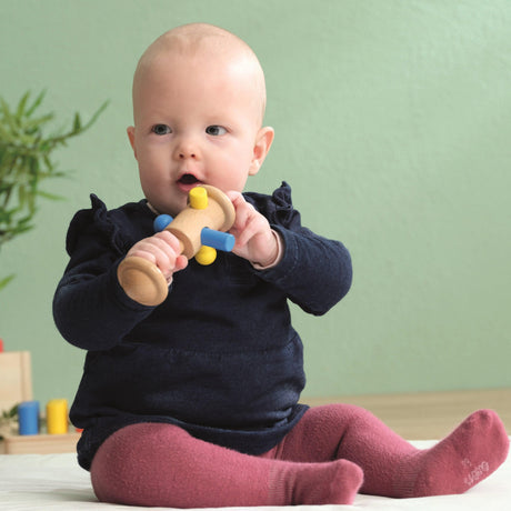 Zabawka montessori Educo Move the Dolio dla niemowlaka, wspiera rozwój motoryki, koordynację oko-ręka i stymuluje odruchy chwytania.