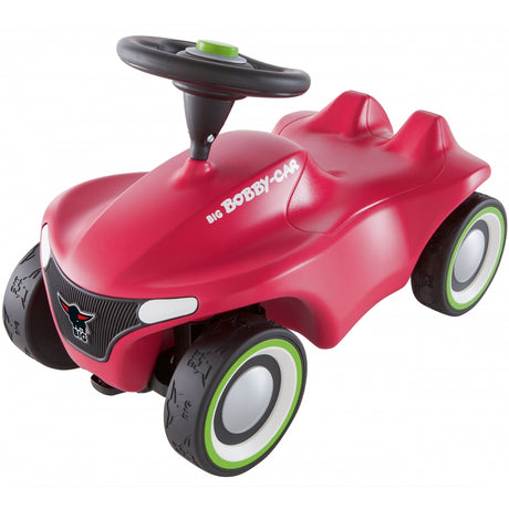 Różowy jeździk Big Neo dla dziewczynki z ergonomicznym designem, skrętnymi kółkami i klaksonem dla bezpiecznej zabawy.