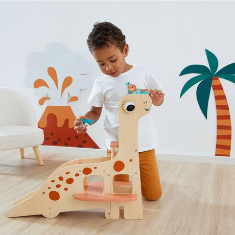 Drewniany garaż Janod Dinozaury z windą i akcesoriami dla dzieci, idealny na autka, solidny i kreatywny plac zabaw.