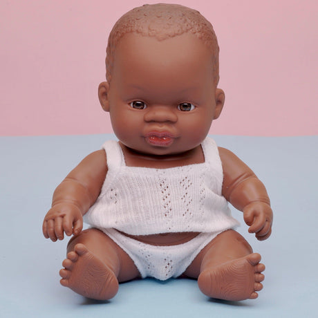 Anatomicznie poprawna lalka bobas Miniland 21 cm, Afrykańczyk, ruchome kończyny, waniliowy zapach, wysoka jakość.