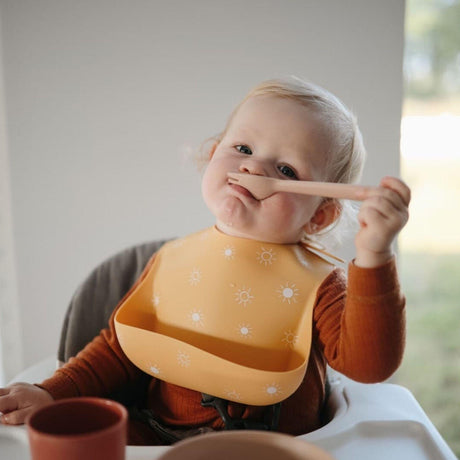 Śliniak silikonowy Mushie Bib dla dziecka, wykonany z miękkiego, nietoksycznego silikonu, designerski wzór, komfort podczas posiłków.