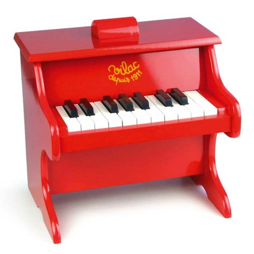 Drewniane czerwone pianino dla dzieci Vilac Mini Piano, 18 klawiszy, z nutami dla początkujących muzyków.